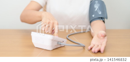 woman checking Blood pressure by Blood pressure monitor with Cuff. Systolic, SYS, Diastolic, DIA, Pulse, Hypertension, Hypotension, Heart rate, Cardiovascular Disease and May World hypertension day woman checking Blood pressure by Blood pressure monitor with Cuff. Systolic, SYS, Diastolic, DIA, Pulse, Hypertension, Hypotension, Heart rate, Cardiovascular Disease and May World hypertension day 141546832