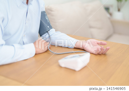 Man checking Blood pressure by Blood pressure monitor with Cuff. Systolic, SYS, Diastolic, DIA, Pulse, Hypertension, Hypotension, Heart rate, Cardiovascular Disease and May World hypertension day Man checking Blood pressure by Blood pressure monitor with Cuff. Systolic, SYS, Diastolic, DIA, Pulse, Hypertension, Hypotension, Heart rate, Cardiovascular Disease and May World hypertension day 141546905