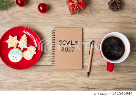2027 GOAL with notebook, black coffee cup, Christmas cookies and pen on wood table. Xmas, Happy New Year, Resolution, To do list, Strategy and Plan concept 2027 GOAL with notebook, black coffee cup, Christmas cookies and pen on wood table. Xmas, Happy New Year, Resolution, To do list, Strategy and Plan concept 141546944