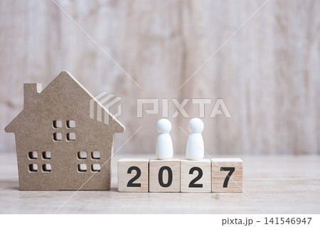 2027 Happy New Year with house model on table wooden background. Banking, real estate, investment, financial, savings and New Year Resolution concepts 2027 Happy New Year with house model on table wooden background. Banking, real estate, investment, financial, savings and New Year Resolution concepts 141546947