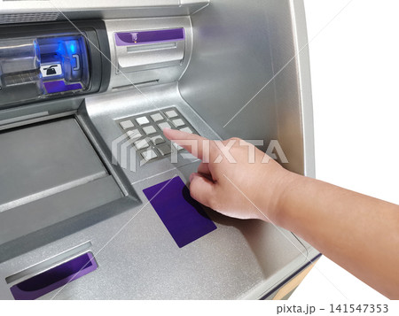 The hand interacts with the ATM keyboard White background. 141547353
