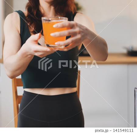 Woman preparing green smoothie in bright kitchen with fresh fruits and vegetables, healthy eating lifestyle moment in natural daylight Woman preparing green smoothie in bright kitchen with fresh fruits and vegetables, healthy eating lifestyle moment in natural daylight 141549111