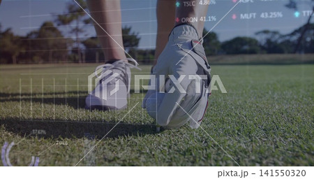 Placing golfer's gloved hand, positioning white golf ball on tee on fairway with digital overlays Placing golfer's gloved hand, positioning white golf ball on tee on fairway with digital overlays 141550320