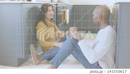 Talking couple in mustard sweater, white shirt on kitchen floor with ceramic mug and HUD overlay 141550617
