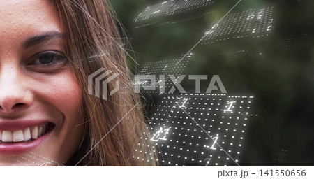 Smiling mid-adult woman showing left face portrait in foliage, with glowing dotted 1 grid 141550656