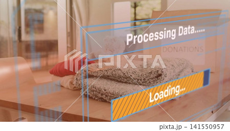 Displaying gray towel stack resting on table in living room by glass door, HUD, donation box Displaying gray towel stack resting on table in living room by glass door, HUD, donation box 141550957