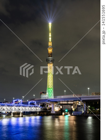Night view of Tokyo Skytree, with beautiful reflections of the majestic tower in the Sumida River, it's the primary television and radio broadcast site in the Kanto region, Japan. Night view of Tokyo Skytree, with beautiful reflections of the majestic tower in the Sumida River, it's the primary television and radio broadcast site in the Kanto region, Japan. 141551695