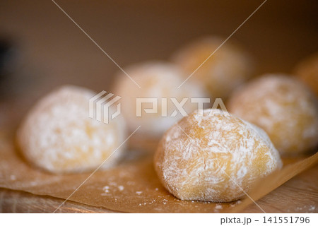 Baked sweet pastry balls in powdered sugar close up 141551796