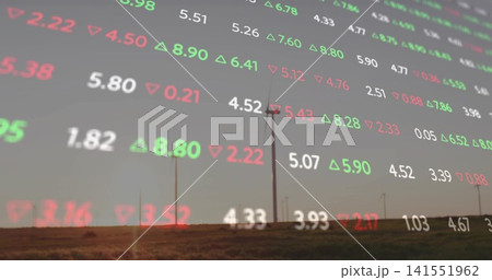 Displaying translucent market-data overlay covering wind farm at dusk, showing turbines and tickers 141551962