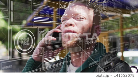 Talking man in dark green sweater holding smartphone to ear at cafe window, with HUD overlays 141552079