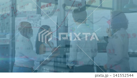 Collaborating colleagues reviewing charts in meeting room in business attire, with glass partition Collaborating colleagues reviewing charts in meeting room in business attire, with glass partition 141552544