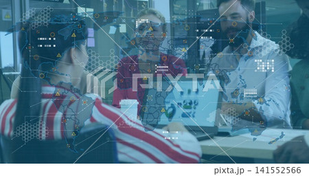 Discussing team wearing red sweater pointing at laptop charts on office table, with projected map Discussing team wearing red sweater pointing at laptop charts on office table, with projected map 141552566