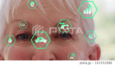 Gazing senior woman showing augmented-reality data overlay in softly lit room, CO2 and water icons Gazing senior woman showing augmented-reality data overlay in softly lit room, CO2 and water icons 141552986