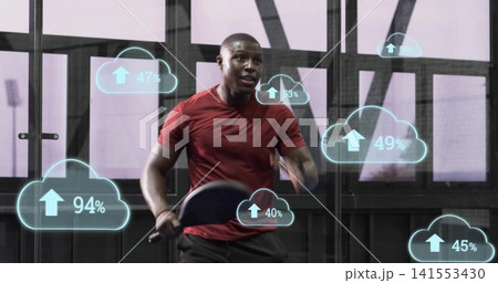 Sprinting man in red shirt dark shorts gripping cardio bars in gym, cloud overlays with percent Sprinting man in red shirt dark shorts gripping cardio bars in gym, cloud overlays with percent 141553430
