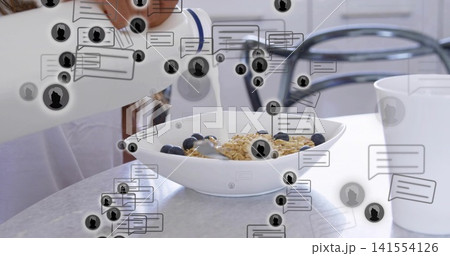 Pouring hand in white long-sleeve adding milk to cereal bowl with blueberries in kitchen overlays Pouring hand in white long-sleeve adding milk to cereal bowl with blueberries in kitchen overlays 141554126
