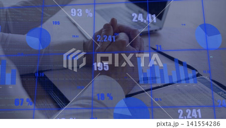 Analyzing two men in dress shirts reviewing financials in meeting room with laptop and blue overlay Analyzing two men in dress shirts reviewing financials in meeting room with laptop and blue overlay 141554286
