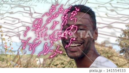 Smiling mid-adult man wearing white T-shirt showing neon-pink circuit overlay outdoors, copy space Smiling mid-adult man wearing white T-shirt showing neon-pink circuit overlay outdoors, copy space 141554533