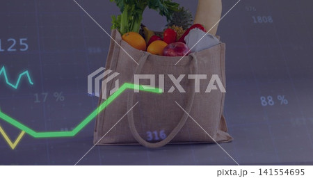 Displaying jute tote holding bread greens oranges apples red pepper on tabletop, with chart overlay Displaying jute tote holding bread greens oranges apples red pepper on tabletop, with chart overlay 141554695