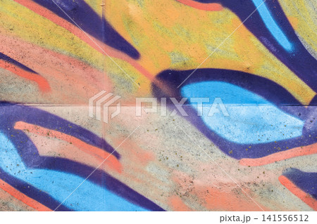 Bold, colorful graffiti mural sprayed on a concrete wall Bold, colorful graffiti mural sprayed on a concrete wall 141556512