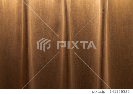 Luxurious brown velvet curtain with soft vertical folds Luxurious brown velvet curtain with soft vertical folds 141556523