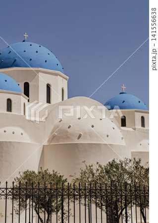 Low angle view of iconic blue domes of Holy Cross Church against clear sky in Perissa village Santorini island Greece for Mediterranean travel stock photo Low angle view of iconic blue domes of Holy Cross Church against clear sky in Perissa village Santorini island Greece for Mediterranean travel stock photo 141556638