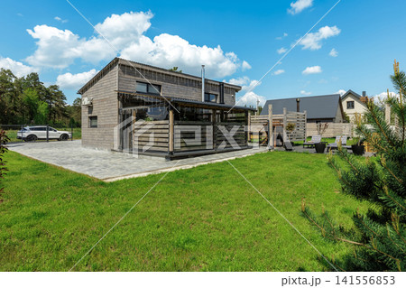 Modern Country House Exterior with Paved Yard and Lawn Modern Country House Exterior with Paved Yard and Lawn 141556853