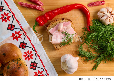 Traditional Ukrainian Feast Composition with Salo, Pampushky, and Spices 141557569