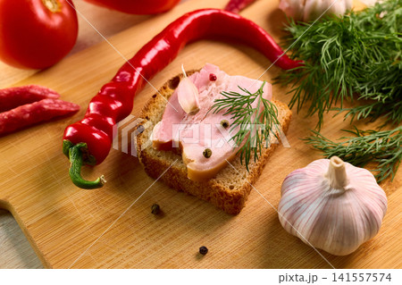 Traditional Ukrainian Salo Sandwich with Spices and Vegetables 141557574