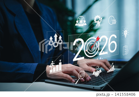 Business Goals and Growth Strategy for 2026 Concept. Businessperson working on a laptop with the year 2026, target icons, and business growth symbols, challenges strategic planning and future success. Business Goals and Growth Strategy for 2026 Concept. Businessperson working on a laptop with the year 2026, target icons, and business growth symbols, challenges strategic planning and future success. 141558406