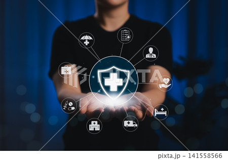 Health Insurance and Medical Protection Concept. Person holding medical cross shield with healthcare icons, symbolizing health insurance, care, medical coverage, medication, and patient services. Health Insurance and Medical Protection Concept. Person holding medical cross shield with healthcare icons, symbolizing health insurance, care, medical coverage, medication, and patient services. 141558566