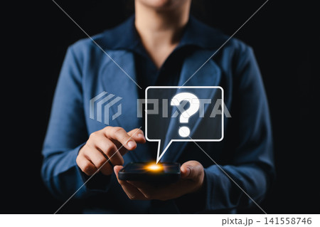 Question Mark Icon Above Smartphone Representing FAQ Concept. Woman interacts with smartphone glowing screen and digital question mark icon, symbolizing help service, FAQ, inquiry, and online support. 141558746