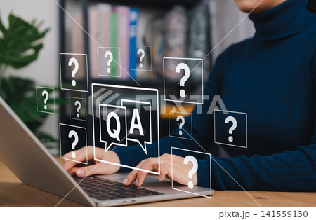 Q and A Support. Woman typing on laptop with Q&A and question mark icons. Concept of online customer support, FAQ system, knowledge base, digital consultation and automated question answering service. 141559130