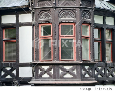 Ornate timber framed bay window with decorative plaster infill Ornate timber framed bay window with decorative plaster infill 141559319