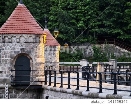 Stone riverside turret and iron bridge railing at dusk Stone riverside turret and iron bridge railing at dusk 141559345