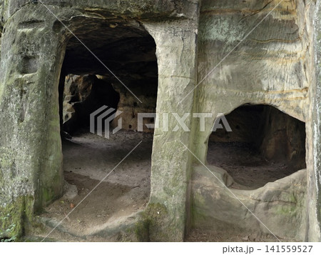 Weathered sandstone cave openings with carved arches Weathered sandstone cave openings with carved arches 141559527