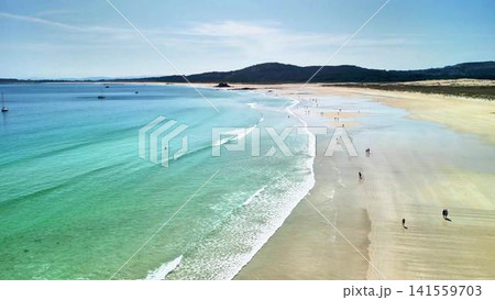 Experience the breathtaking and stunning aerial view of the serene beach with clear waters 141559703