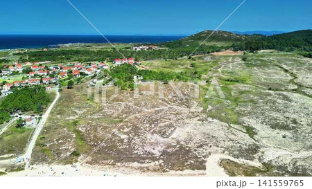 Stunning Aerial View of the Coastal Landscape Featuring a Sandy Beach and Lush Green Hills Stunning Aerial View of the Coastal Landscape Featuring a Sandy Beach and Lush Green Hills 141559765