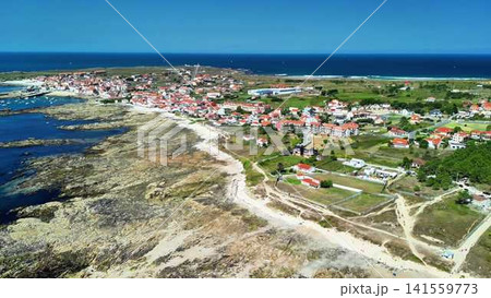 A Beautiful Aerial View of a Coastal Village Surrounded by Tranquil and Calm Waters 141559773