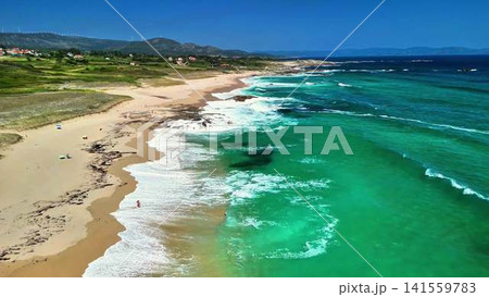 Experience the breathtaking and stunning aerial views of a serene beach with turquoise waters 141559783