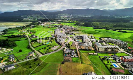 Stunning aerial views of the scenic coast with lush fields and cozy homes nearby Stunning aerial views of the scenic coast with lush fields and cozy homes nearby 141559842
