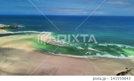 Experience the stunning aerial view of a serene and picturesque coastal landscape Experience the stunning aerial view of a serene and picturesque coastal landscape 141559843