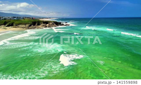 Breathtaking Aerial View of Turquoise Ocean Waves Meeting a Scenic Coastal Landscape 141559898