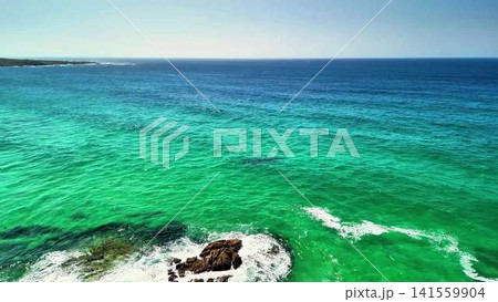 Behold the stunning aerial view of the turquoise ocean and serene coastline, showcasing beauty Behold the stunning aerial view of the turquoise ocean and serene coastline, showcasing beauty 141559904