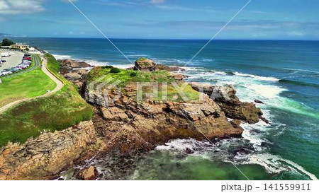 A Stunning Coastal Landscape Showcasing a Rocky Shore and Waves Crashing on the Beach A Stunning Coastal Landscape Showcasing a Rocky Shore and Waves Crashing on the Beach 141559911