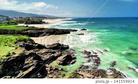 Stunning Coastal View of a Serene Beach and a Rocky Shoreline Surrounded by Natures Beauty Stunning Coastal View of a Serene Beach and a Rocky Shoreline Surrounded by Natures Beauty 141559914
