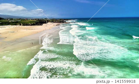 Beautiful Aerial View of a Serene Beach Surrounded by Turquoise Waves and Blue Skies Beautiful Aerial View of a Serene Beach Surrounded by Turquoise Waves and Blue Skies 141559918