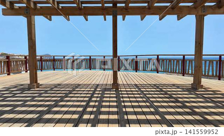 Enjoy the breathtaking scenic ocean view from a charming wooden pavilion deck today 141559952