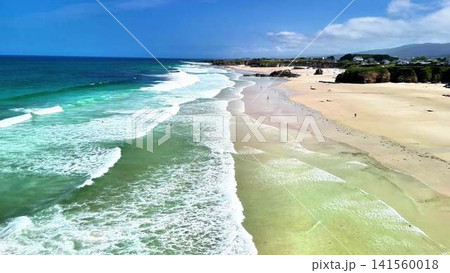 Enjoy the Stunning Aerial View of the Calm Beach and Gentle Waves Beneath a Clear Sky Enjoy the Stunning Aerial View of the Calm Beach and Gentle Waves Beneath a Clear Sky 141560018