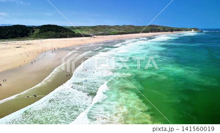 Experience the Stunning Aerial View that Showcases a Vibrant Beach along with Ocean Waves 141560019
