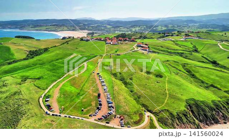 Experience a breathtaking aerial view of lush green hills and a captivating scenic beach Experience a breathtaking aerial view of lush green hills and a captivating scenic beach 141560024